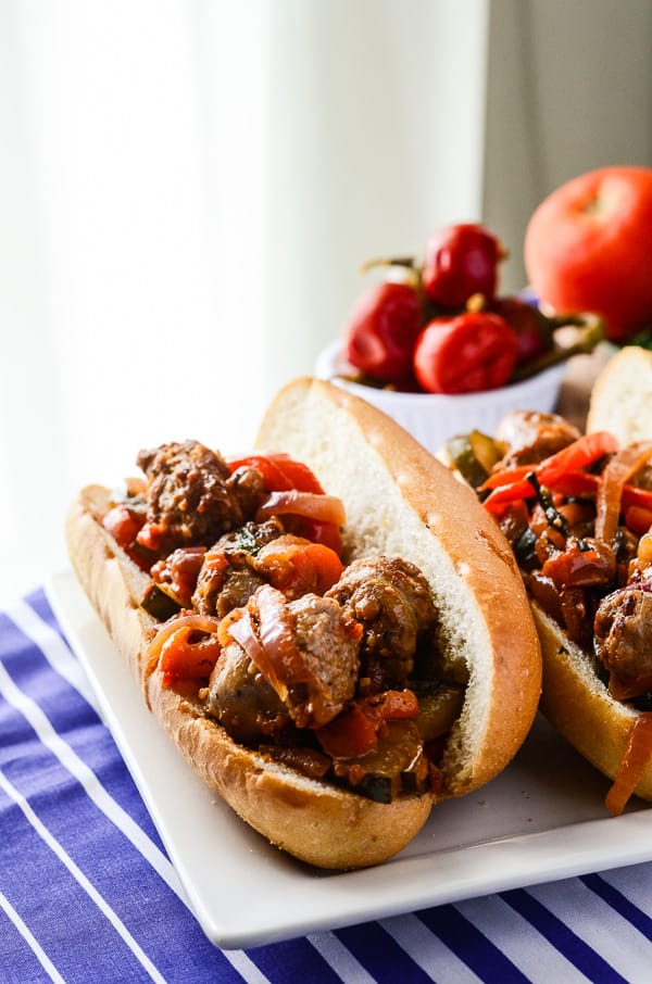 Greek-Style Sausage & Peppers Sandwich | A simply perfect classic sausage and peppers sandwich, made in one pan and taken to foreign places by the use of dill, cucumber, and Nikos® Feta Cheese!