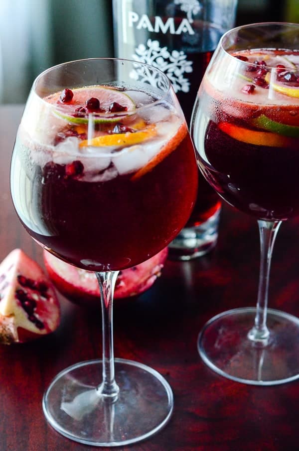 Pomegranate Summer Sangria | Celebrate the warmth of the season with this deep yet refreshing summer sangria, bursting with citrus, dark rum, full red wine, & PAMA Pomegranate Liqueur!
