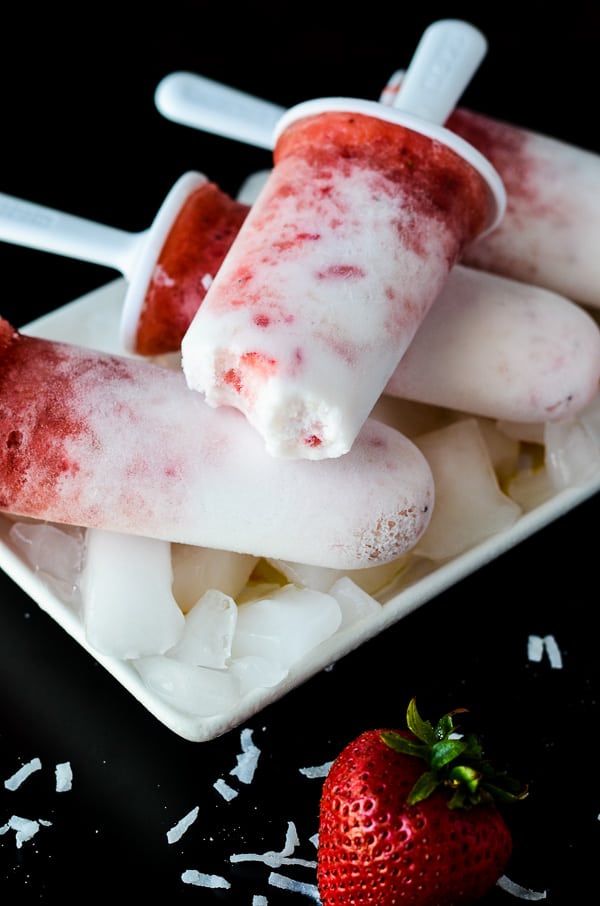 Strawberry Pina Colada Popsicles | A frosty, refreshing treat, made with fresh fruit and coconut milk, sweetened with agave, and spiked with coconut rum for the grown ups!