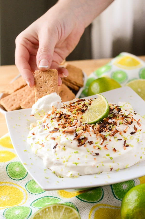 Coconut Key Lime Cheesecake Dip | A fluffy, refreshing, and versatile desert hybrid - key lime cheesecake dip combined with freshly toasted coconut is perfect for graham cracker dunkin'! 