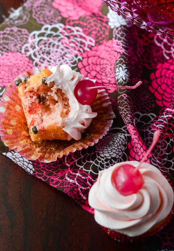 Cherry Chocolate Chip Cupcakes with Pink Chocolate Buttercream | Think pink! These delightful maraschino cherry chocolate chip cupcakes are topped with a fluffy pink chocolate buttercream, and were baked (and eaten!) for a great cause!
