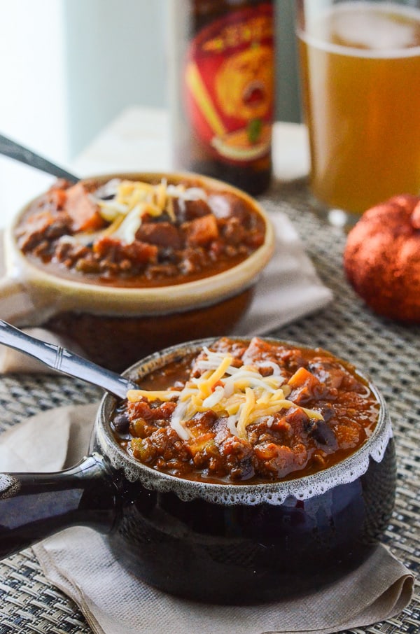 Spicy Pumpkin Sweet Potato Chili | This is not your ordinary crock pot chili - it's packed with pumpkin, sweet potato, beef, pork, beans, and tons of fall flavor! 
