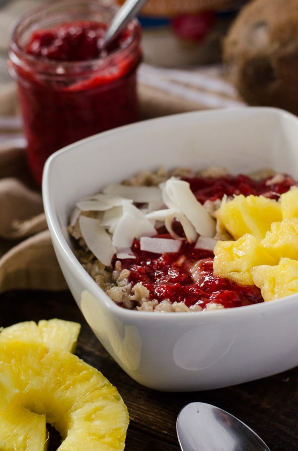 Pineapple Coconut Oatmeal with Strawberry Chia Jam | Creamy oatmeal, cooked in coconut milk and maple syrup, and swirled with homemade strawberry chia jam, fresh pineapple, and even more coconut - so good, it could be dessert!