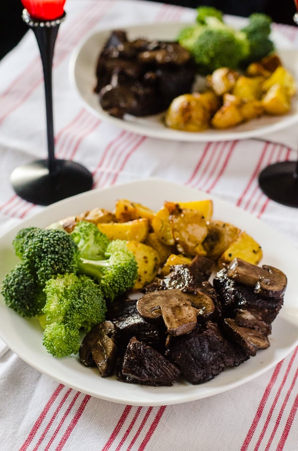 Red Wine Mushroom Braised Beef | Tender, juicy beef, braised in a delicious red wine & mushroom gravy - served with herbed roasted potatoes and your favorite veggie, it makes for a wonderful Sunday Supper!