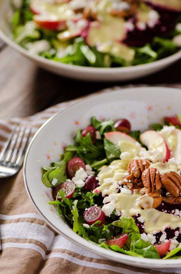 Crunchy Beet and Arugula Salad | These ain't your granny's beets! Fresh arugula, tossed with crisp apples, sweet grapes, crunchy toasted pecans, pickled beets, tangy feta, and drizzled with an avocado-lime vinaigrette. 