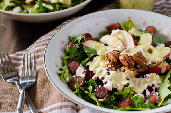 Crunchy Beet and Arugula Salad | These ain't your granny's beets! Fresh arugula, tossed with crisp apples, sweet grapes, crunchy toasted pecans, pickled beets, tangy feta, and drizzled with an avocado-lime vinaigrette.
