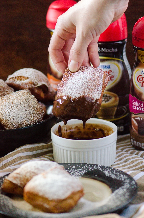 Salted Caramel Beignets | Bring a little New Orleans into your kitchen - salted caramel flavored sweet dough beignets, deep-fried and served hot with a sweet chocolate dipping sauce!