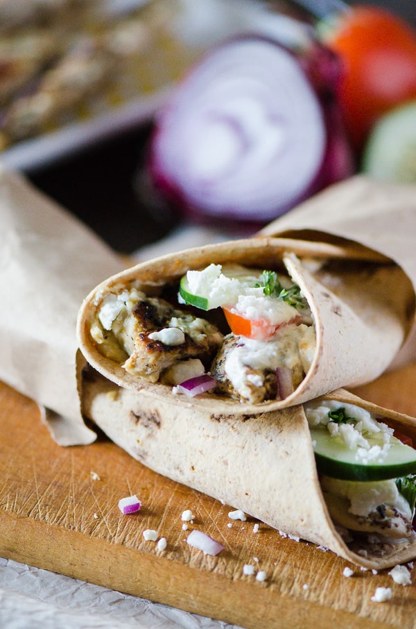 Souvlaki Chicken Wraps with Homemade Tzatziki | Flatbread stuffed with hummus, souvlaki chicken, veggies, feta cheese, and homemade tzatziki, these easy Greek-style wraps are perfect for lunch on the go or a fun Sunday Supper!
