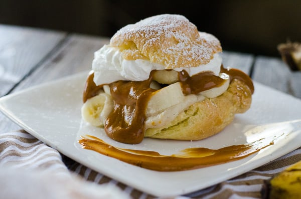 Banoffee Cream Puffs | A twist on an English dessert - bananas, toffee, and whipped cream, taken out of the pie crust and nestled in a light, fluffy homemade cream puff!
