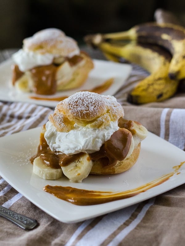 Banoffee Cream Puffs | A twist on an English dessert - bananas, toffee, and whipped cream, taken out of the pie crust and nestled in a light, fluffy homemade cream puff!