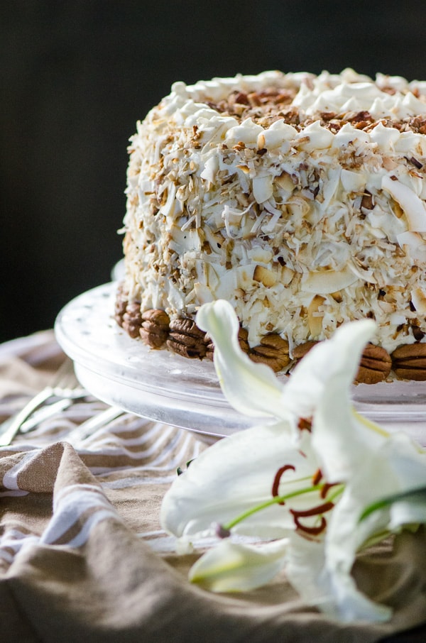 Italian Cream Cheesecake | Two layers of classic Italian Cream Cake and a complementary layer of coconut pecan cheesecake sandwiched in the middle make for one amazing dessert! Così bello! 