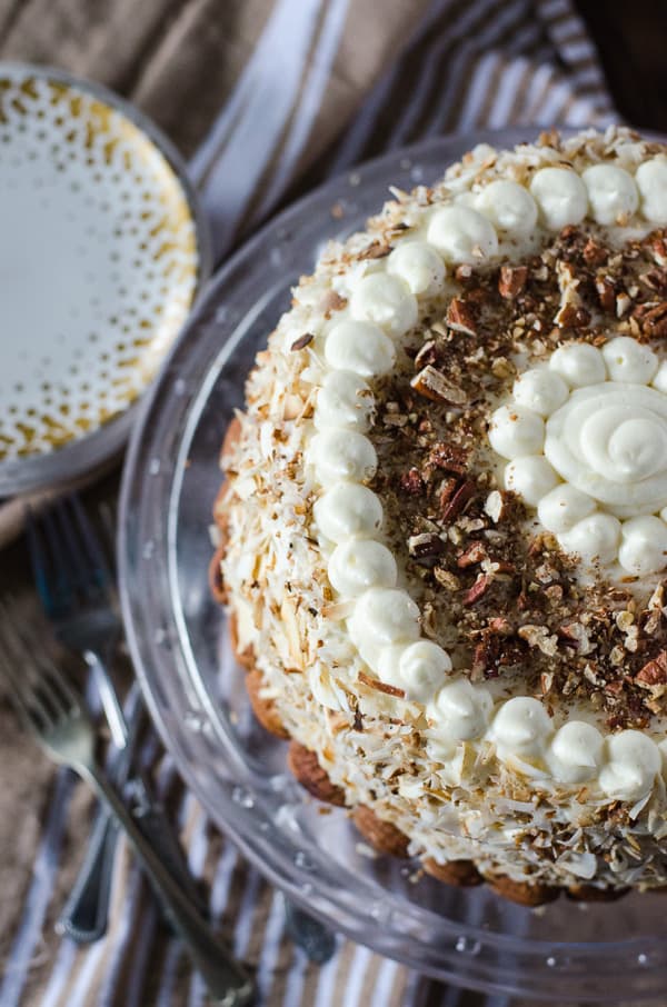 Italian Cream Cheesecake | Two layers of classic Italian Cream Cake and a complementary layer of coconut pecan cheesecake sandwiched in the middle make for one amazing dessert! Così bello! 