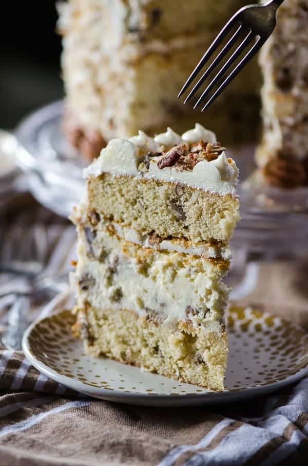 Italian Cream Cheesecake | Two layers of classic Italian Cream Cake and a complementary layer of coconut pecan cheesecake sandwiched in the middle make for one amazing dessert! Così bello!