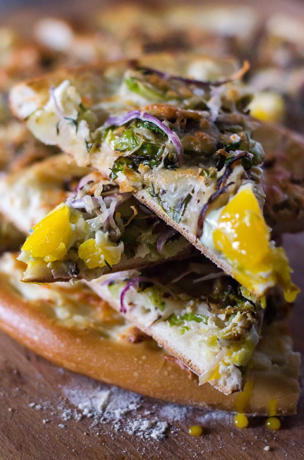 Shiitake “Bacon” and Shredded Brussels Sprouts Pizza | Pan-roasted shiitake mushrooms and shredded Brussels sprouts take center stage on this earthy vegetarian pizza, playing nicely with melty ricotta and Fontina and a playful egg on top.