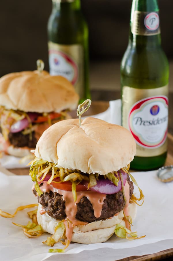 A saucy, simply seasoned burger, topped with sauteed cabbage, tomato and onion, the Chimichurri Burger is Dominican street food at its finest! 