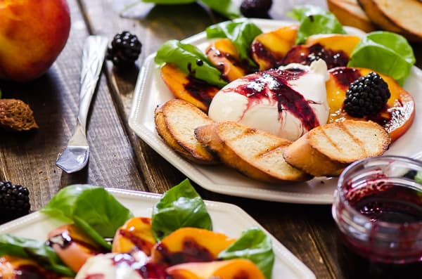 Transform a favorite Italian salad - Grilled Peach Caprese combines fresh peaches, burrata, basil, and blackberry balsamic into a perfect summer day appetizer!