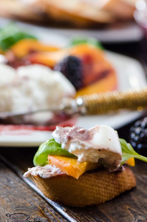 Transform a favorite Italian salad - Grilled Peach Caprese combines fresh peaches, burrata, basil, and blackberry balsamic into a perfect summer day appetizer!