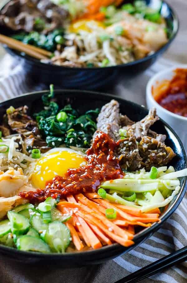 Step away from the buffet and try something different! Korean Bibimbap is an Asian food lover's dream - a bowl full crispy rice, lots of sautéed veggies, a fried egg, and some thinly sliced beef, all drizzled with a spicy sauce.