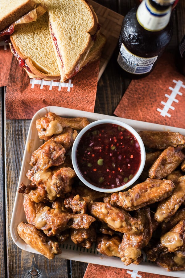 Calling all football fans - Spicy PB&J Wings are here turn a famed childhood sandwich into your new favorite tailgating snack! Dip these peanut butter glazed chicken wings into the strawberry jalapeno glaze and cheer louder than ever before!