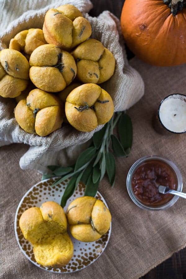 Perfect dinner rolls with a fall twist! These Pumpkin Sage Cloverleaf Rolls are slightly sweet, super fluffy, and smothered in melty sage compound butter.