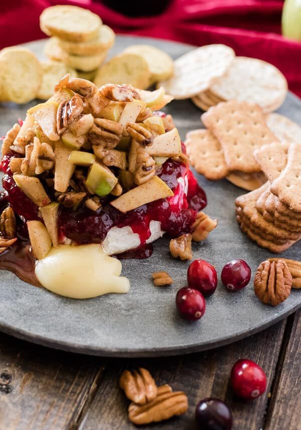 This simple Cranberry Apple Pecan Baked Brie combines tart, sweet, and savory to create an elegant holiday crowd pleaser!