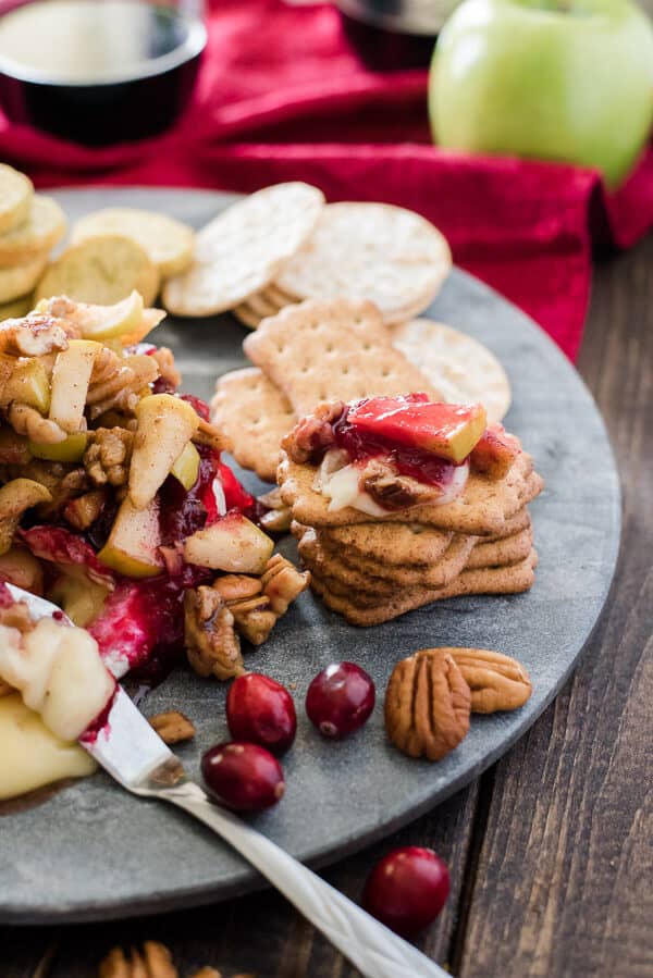 This simple Cranberry Apple Pecan Baked Brie combines tart, sweet, and savory to create an elegant holiday crowd pleaser!