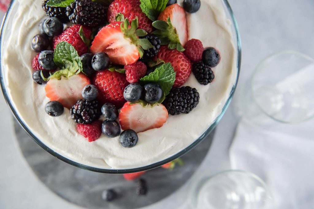 This Chantilly Berry Trifle is a real crowd pleaser! Pound cake, cheesecake filling, whipped cream, and berries marinated in raspberry liqueur make up the layers of this dessert, which is almost too pretty to eat!