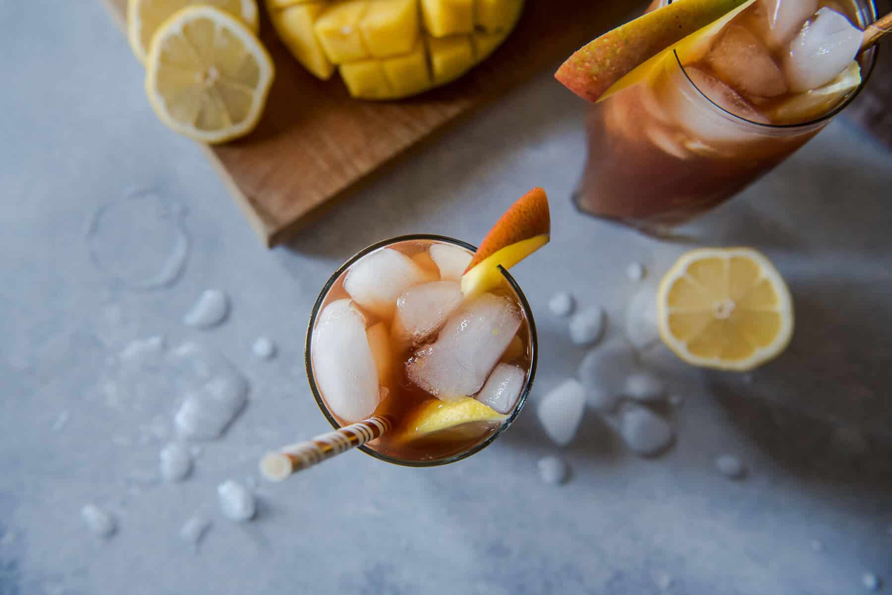 Change up your brunch beverage game with this Southern Spiked Mango Iced Tea! Arnold Palmer-style lemon iced tea combined with homemade mango nectar and a shot of your favorite bourbon is a tasty tropical, Southern way to cool down a balmy morning meal.
