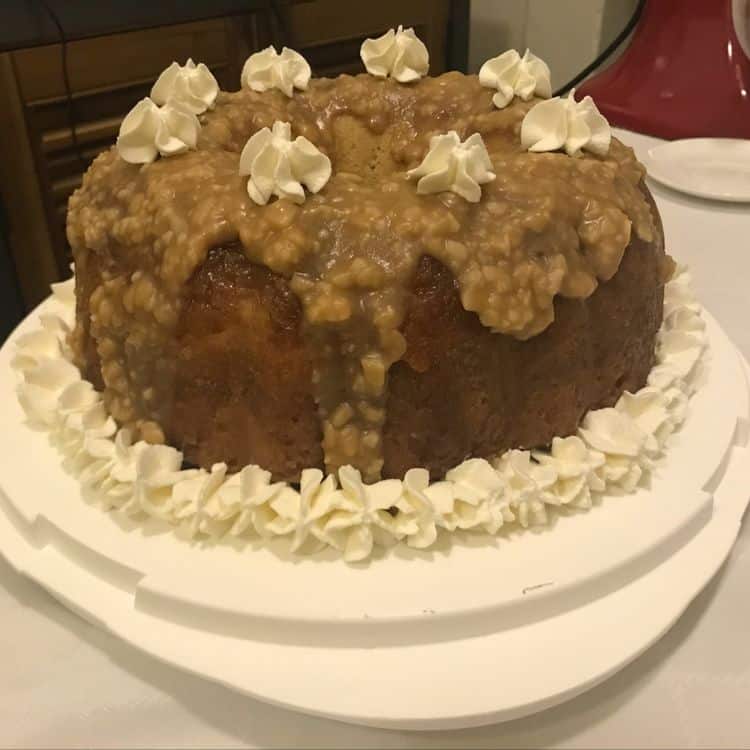 decorated rum cake on a white cake stand