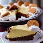 Black Bottom Eggnog Pie | A rich, dark chocolate ganache pudding base, topped with a light and fluffy eggnog mousse, and layered in a spicy gingersnap crust. Say goodbye to the holidays with style!