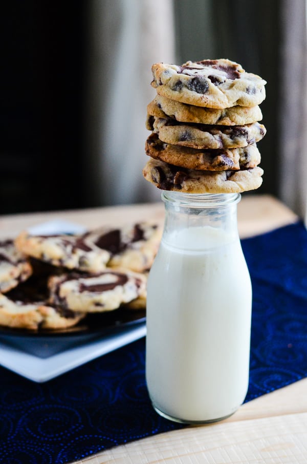a stack of brookies cookies balanced on a milk bottle