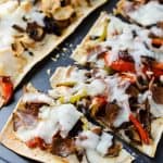 Cheesesteak Flatbread Pizza | These individually sized Cheesesteak Flatbread Pizzas are perfect for lunch or a quick easy dinner, and are a great new take on one of America's favorite sandwiches. Make it with classic beef or switch it up with chicken!