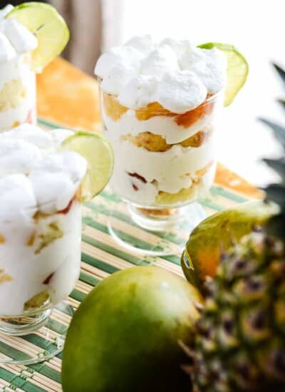 Tropical Yogurt Parfaits on a table with fruit by a window