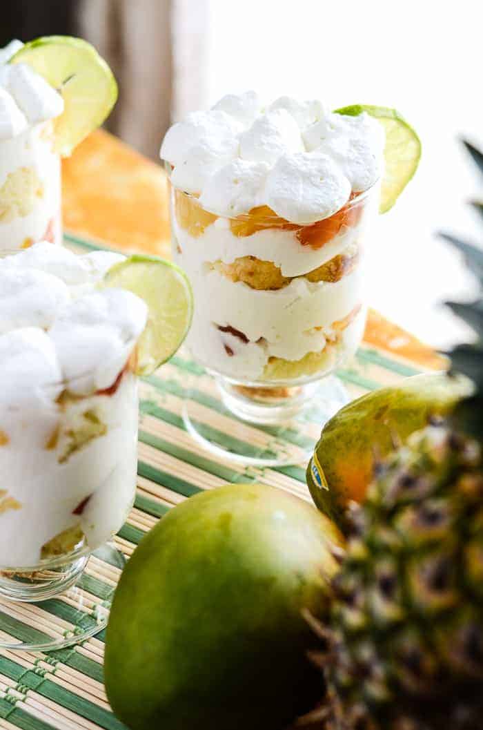 Tropical Yogurt Parfaits on a table with fruit by a window