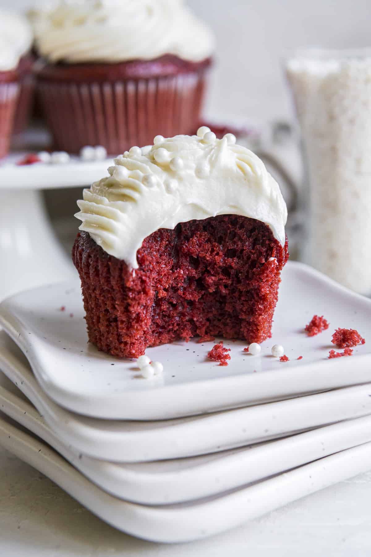 a red velvet cupcake with a bite taken out of it