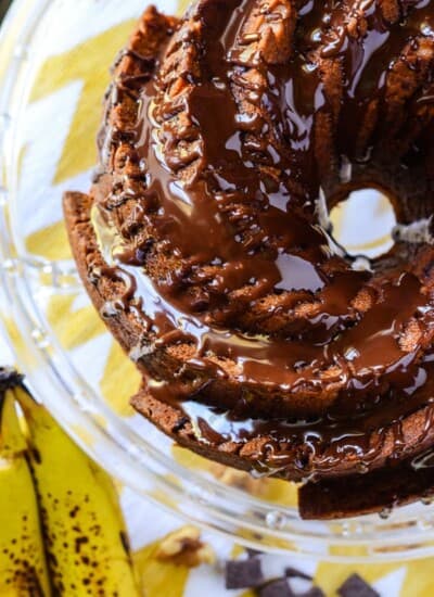 Chunky Monkey Bundt Cake | A favorite ice cream flavor, turned into an incredible bundt cake! This banana chocolate chunk walnut cake is perfect drizzled with ganache & served with a big cup of coffee!