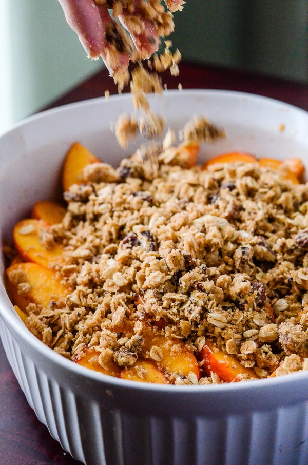 Cinnamon Ginger Peach Crisp | A a spicy, playful nod to fall, using one of summer's favorite fruits marinated in cinnamon whiskey and fresh ginger!