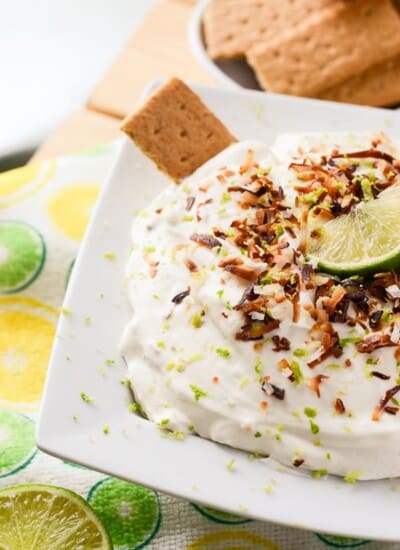 Coconut Key Lime Cheesecake Dip | A fluffy, refreshing, and versatile desert hybrid - key lime cheesecake dip combined with freshly toasted coconut is perfect for graham cracker dunkin'!