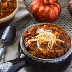 Spicy Pumpkin Sweet Potato Chili | This is not your ordinary crock pot chili - it's packed with pumpkin, sweet potato, beef, pork, beans, and tons of fall flavor!