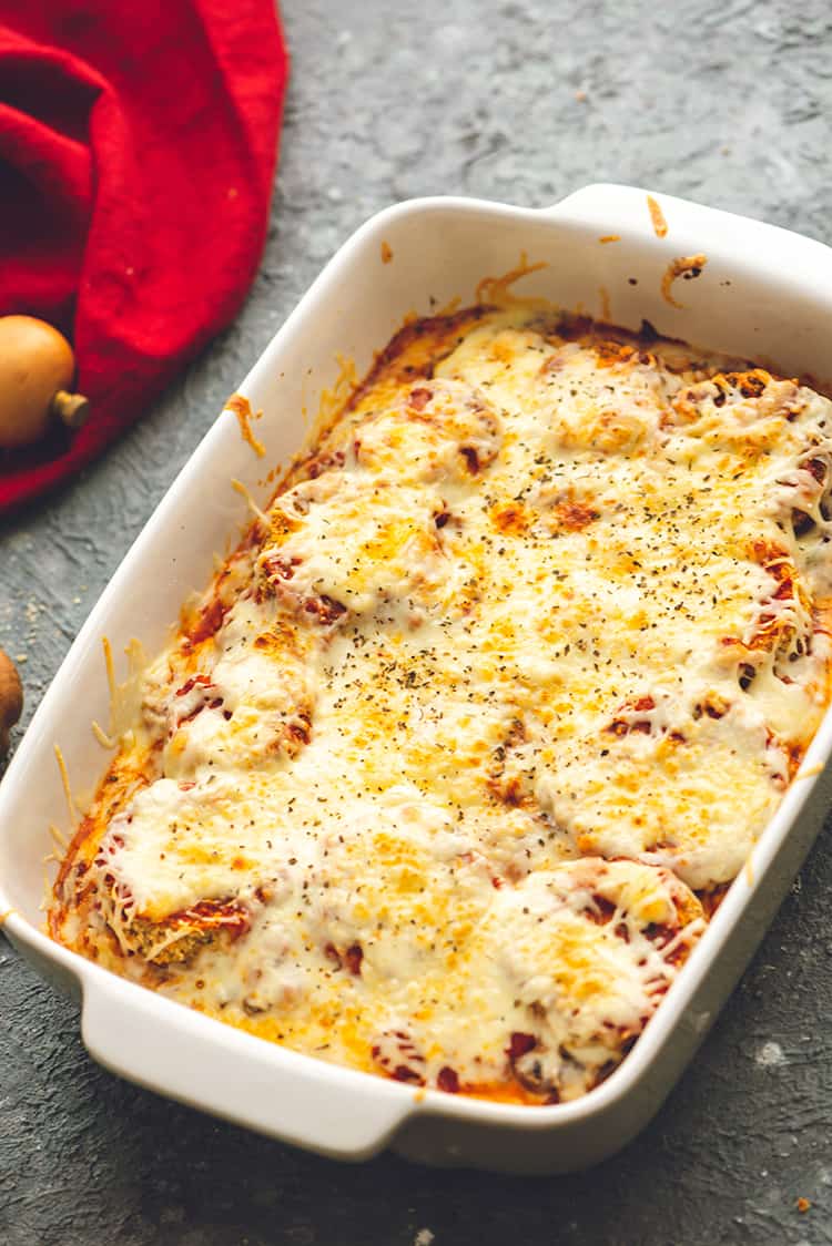 Baked Eggplant Parmesan out in a white casserole dish