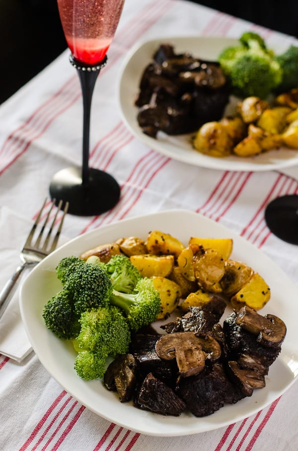 Red Wine Mushroom Braised Beef | Tender, juicy beef, braised in a delicious red wine & mushroom gravy - served with herbed roasted potatoes and your favorite veggie, it makes for a wonderful Sunday Supper!