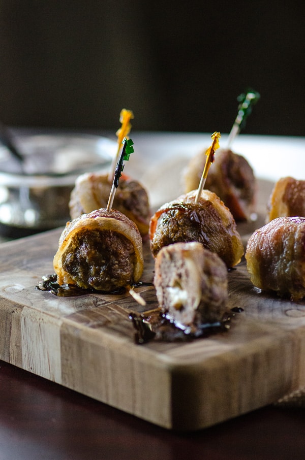 Bacon Wrapped Cheesy Meatballs with Maple Balsamic Sauce | Italian appetizers never tasted so good! Big beef & pork meatballs, stuffed with mozzarella cheese, wrapped in bacon, and drizzled with maple balsamic sauce are all you need to get the party started!