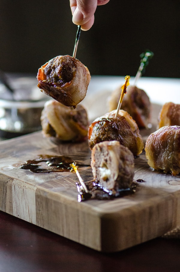 Bacon Wrapped Cheesy Meatballs with Maple Balsamic Sauce | Italian appetizers never tasted so good! Big beef & pork meatballs, stuffed with mozzarella cheese, wrapped in bacon, and drizzled with maple balsamic sauce are all you need to get the party started!