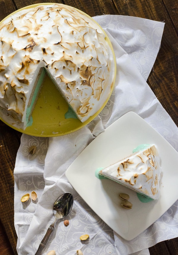 Pistachio Chai Baked Alaska | Pistachio almond ice cream, sandwiched between two layers of vanilla chai cake, all topped with fluffy meringue...and then baked! This old-fashioned dessert is as fun as it is delicious.