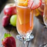Brunch Sangria Mimosas | Can't decide between sangria or mimosa for brunch? Have both! Fresh fruit bathed in pineapple juice, champagne, and a little Creme de Cassis makes for a perfect weekend pick-me-up!