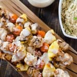 Fresh pineapple, cherry tomatoes, and coconut-marinated chicken take a classic cocktail to the grill and put it on dinner table with these Pina Colada Chicken Skewers!