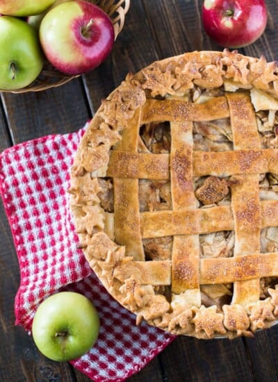 My Nana's Apple Pie is the perfect nostalgic fall dessert! Pounds of thinly sliced and spiced apples wrapped in a tender, flaky crust, decorated for the season - this baby is just begging for a big scoop of ice cream!