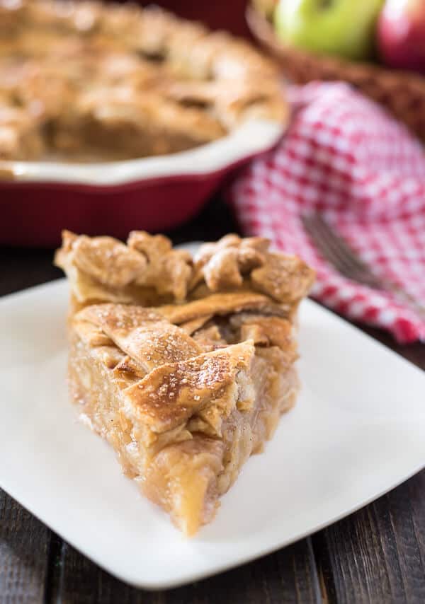 My Nana's Apple Pie is the perfect nostalgic fall dessert! Pounds of thinly sliced and spiced apples wrapped in a tender, flaky crust, decorated for the season - this baby is just begging for a big scoop of ice cream!