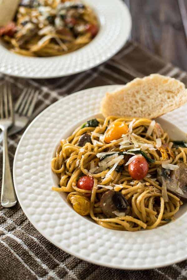 Looking for a delicious quick & easy weeknight meal? It doesn't get much better than One Pot Tomato Basil Pasta - linguine, fresh veggies, and a light, creamy sauce make this a dinner worth repeating!