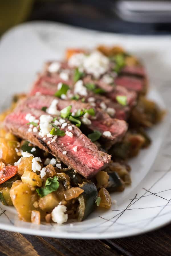 Heat up your next cookout with Spicy Grilled Steak Caponata! Classic eggplant caponata + hot peppers & salsa verde + perfectly grilled steak & crumbly cheese = a recipe for late summer salad perfection!